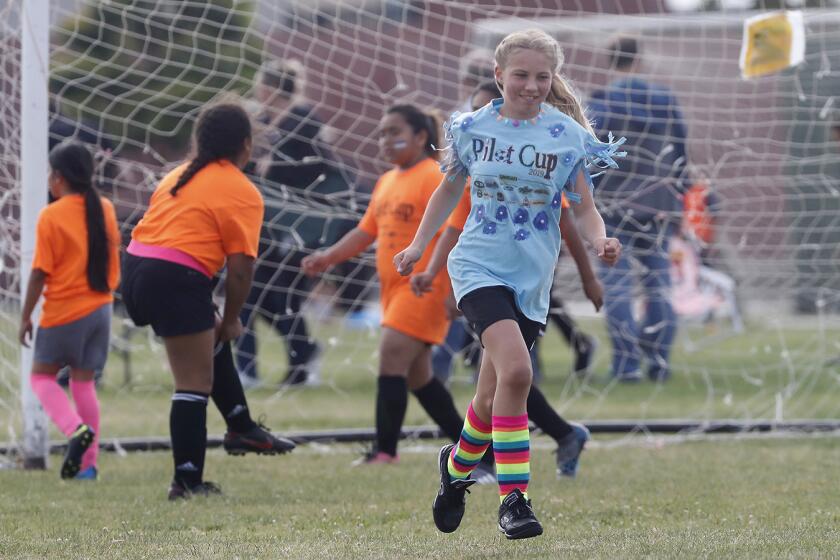 Costa Mesa St. Joachim Catholic School's Ava Farrow is all smiles after increasing her team's lead to 2-0 against Costa Mesa Wilson in a girls' third- and fourth-grade Bronze Division pool-play match at the Daily Pilot Cup on Friday at Costa Mesa High.