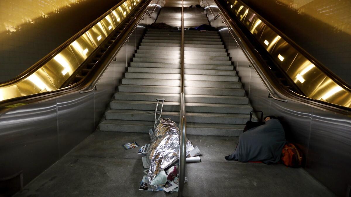 Only the most glaring manifestation of the state's housing crisis: Homeless persons asleep in the early morning on the steps of the Civic Center/ Grand Park Metro Station in Los Angeles.