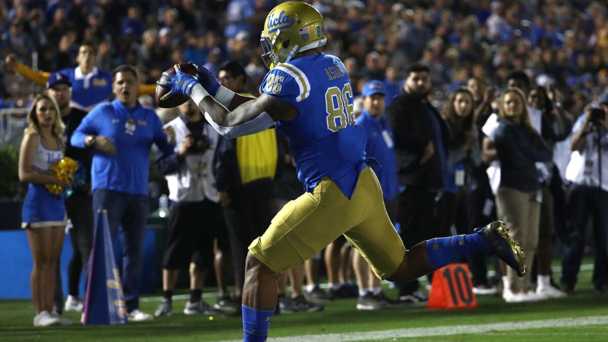UCLA tight end Devin Asiasi catches a touchdown pass during the first half against Arizona at the Rose Bowl on Saturday.