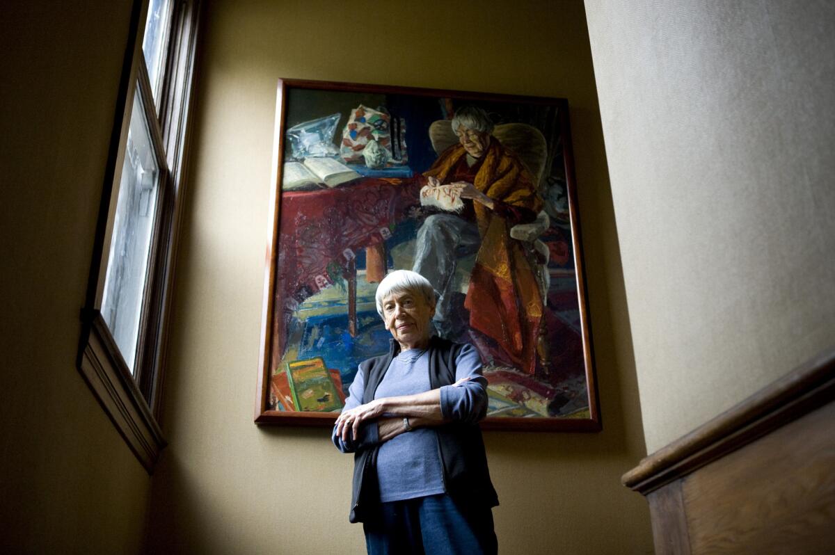 Celebrated science-fiction and fantasy writer Ursula K. Le Guin in front of a portrait painted by Henk Pander.