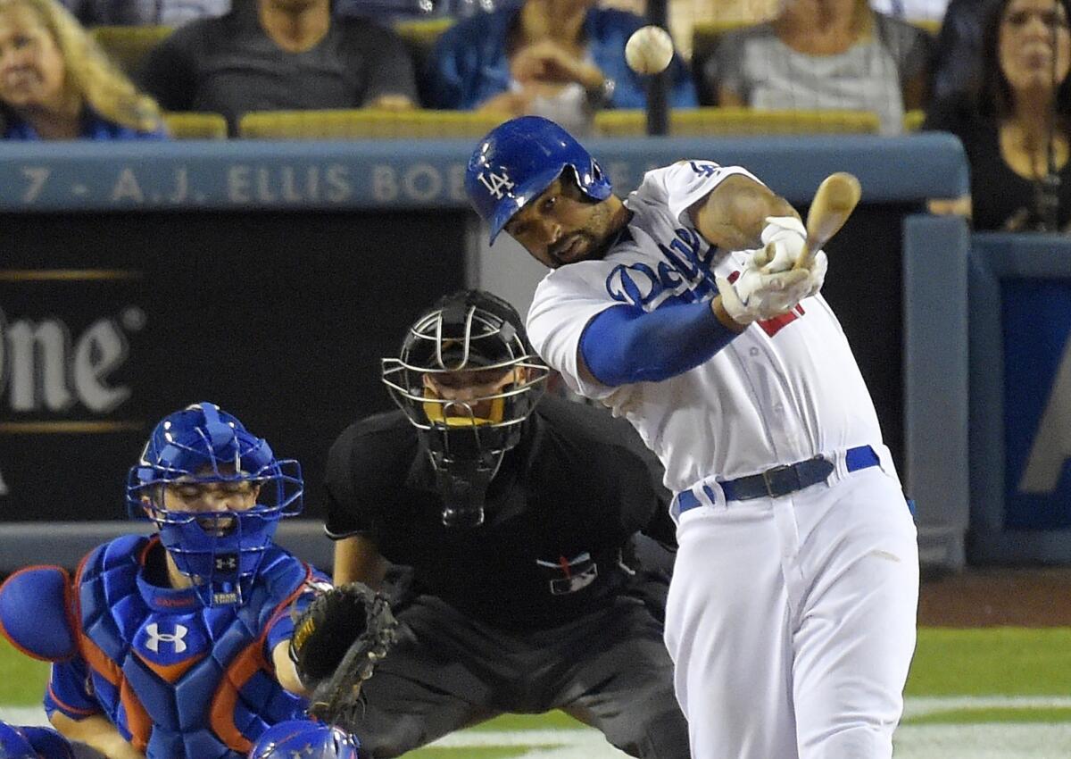 Matt Kemp hits a two-run double in the seventh inning of the Dodgers' series opener with the New York Mets on Friday at Dodger Stadium.