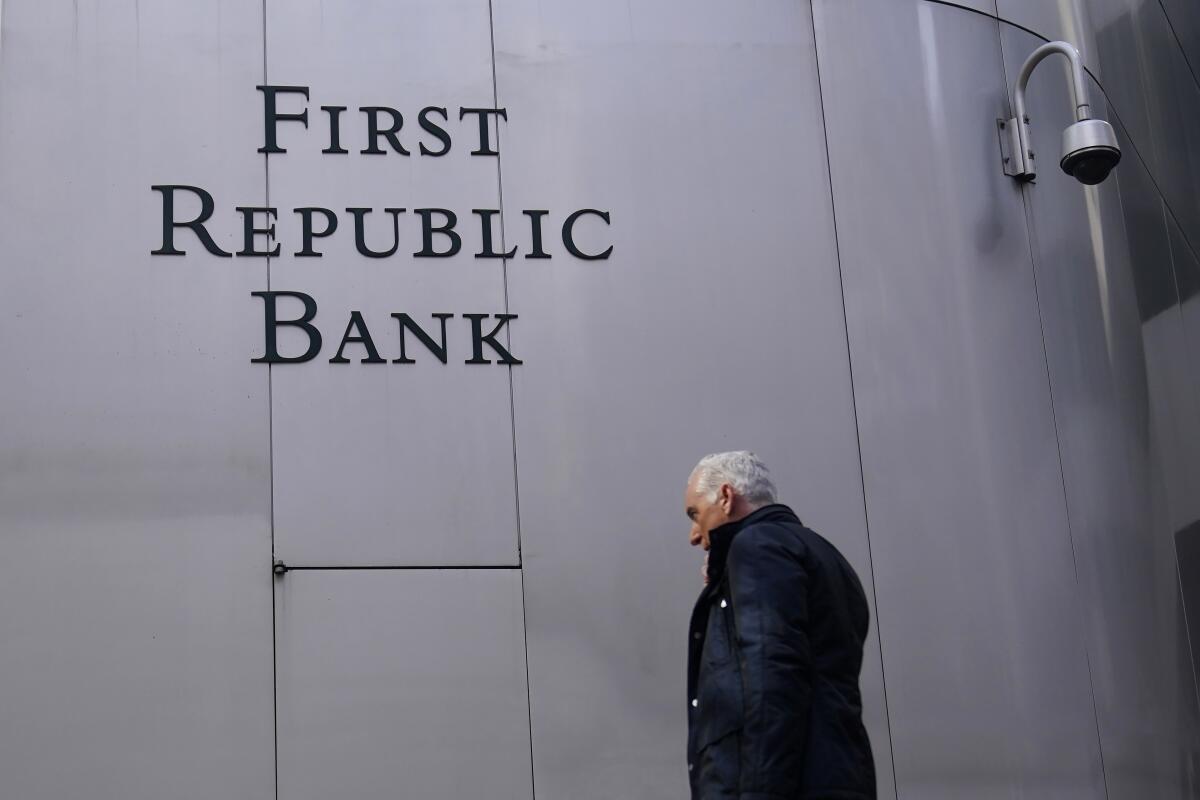 A pedestrian walks past a sign at a First Republic Bank in San Francisco 
