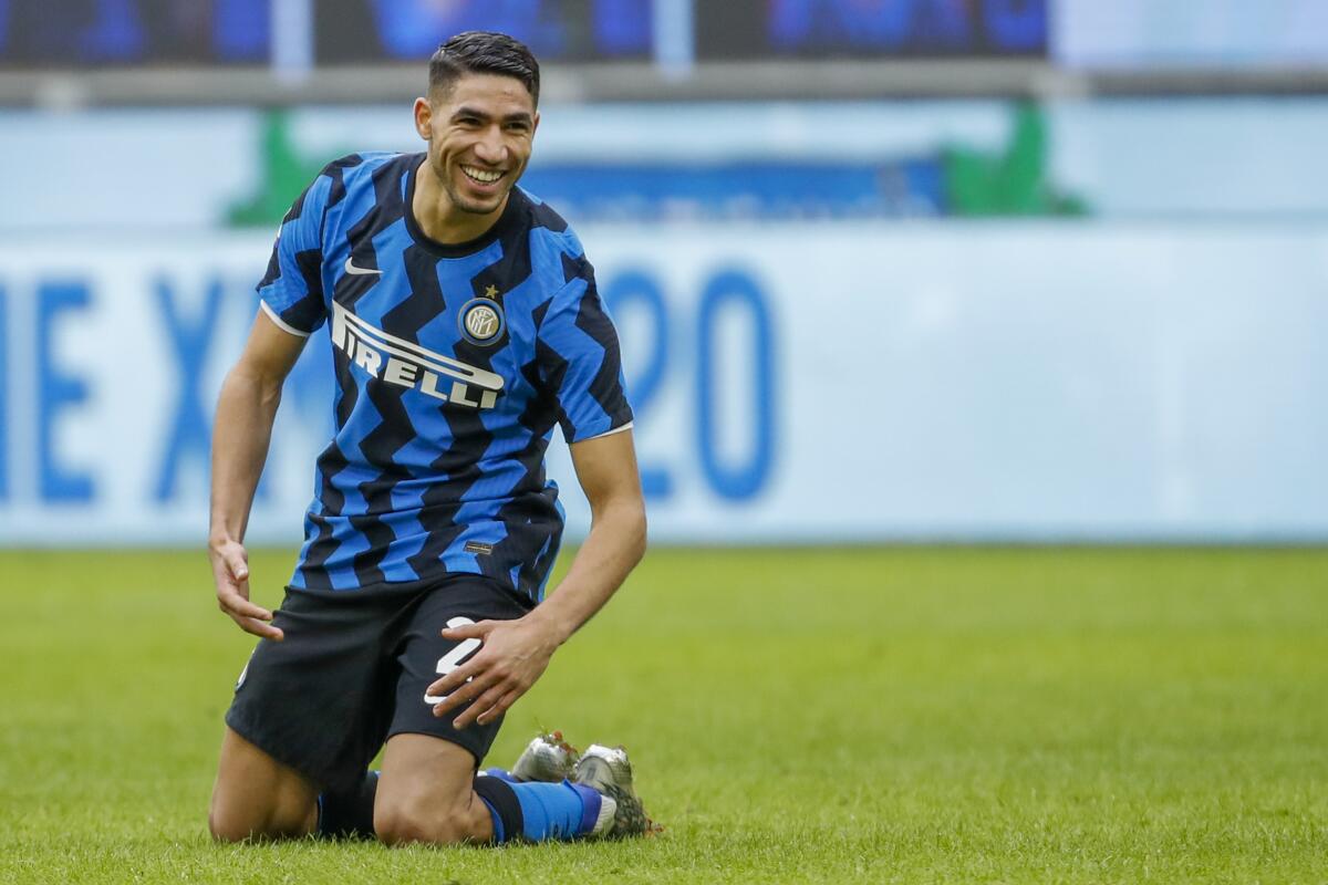 FILE - In this Sunday, Jan. 3, 2021 file photo, Inter Milan's Achraf Hakimi celebrates after he scored his side's sixth goal during the Serie A soccer match between Inter Milan and Crotone at the San Siro Stadium in Milan, Italy. PSG has bolstered its defense by signing Morocco right-back Achraf Hakimi from Inter Milan. PSG says the 22-year-old defender signed a five-year deal until the end of June 2026. Hakimi started his international career in 2016 and played at the 2018 World Cup. (AP Photo/Antonio Calanni, File)