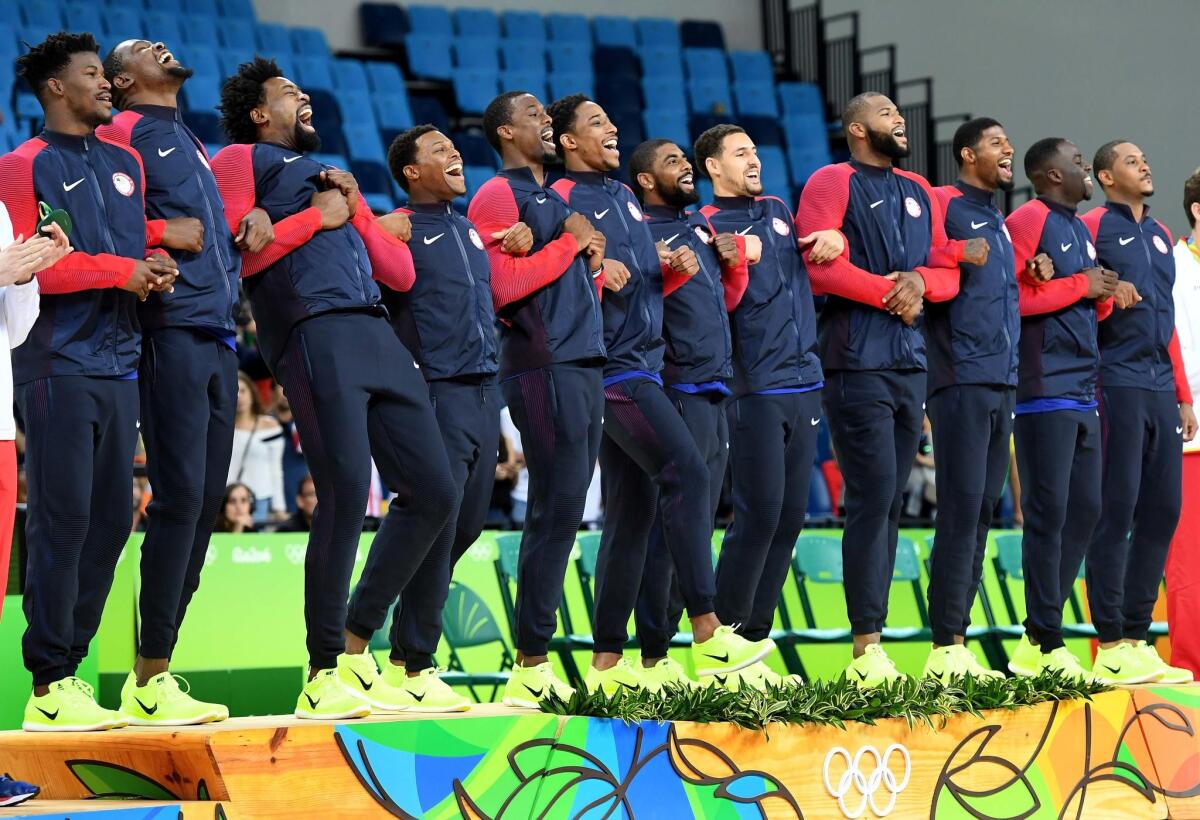 The U.S. men's basketball steps up to podium to receive their gold medals.