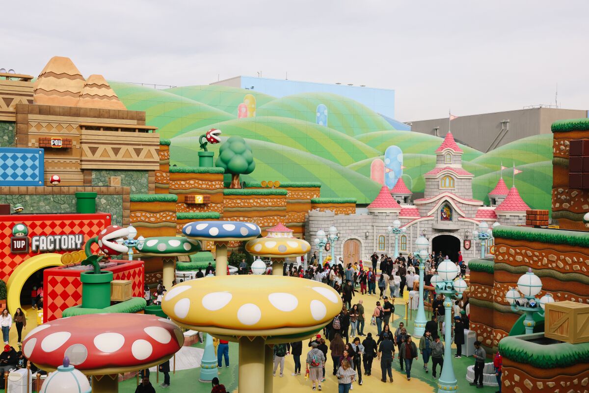 Colorful mushrooms and fantastic architecture with green rolling hills at a theme park