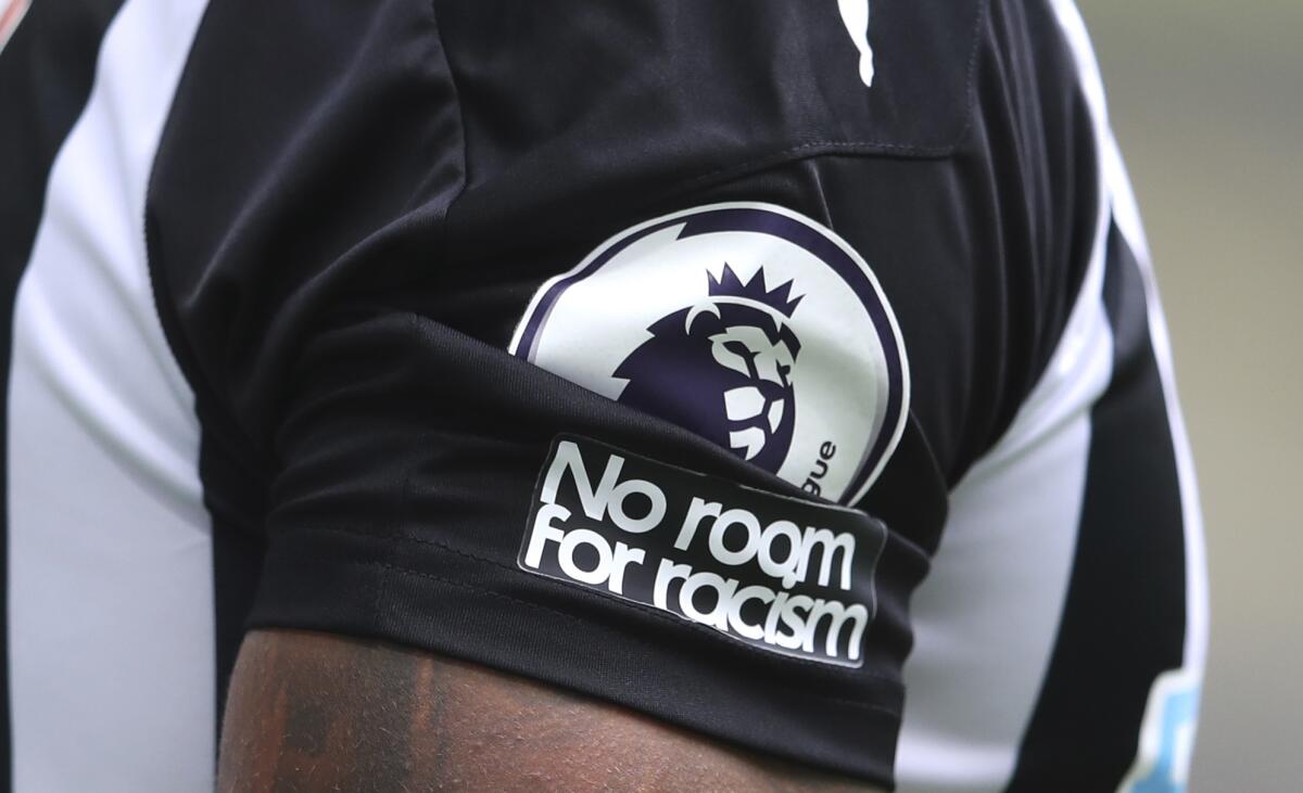 FILE - In this Sunday, Sept. 20, 2020 file photo, Aadetailed view of the "No room for racism" badge on the shirt of Newcastle United's Callum Wilson during the English Premier League soccer match between Newcastle United and Brighton at St. James' Park in Newcastle, England. The leaders of English soccer have asked the heads of Facebook and Instagram to show “basic human decency” by taking more robust action to eradicate racism and for users’ identities to be verified. There has been growing outrage that players from the Premier League to the Women’s Super League have been targeted with abuse on Twitter and Facebook-owned Instagram. (Alex Pantling /Pool via AP, File)