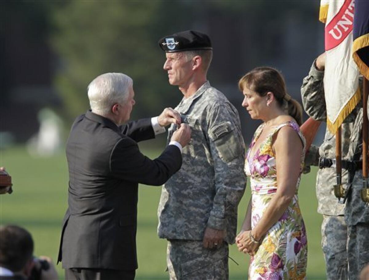 Defense Secretary Robert M. Gates, left, awards the Distinguished Service Medal to Gen. Stanley McChrystal as he is honored at a retirement ceremony at Fort McNair in Washington, Friday, July 23, 2010. His wife Annie stands at right. McChrystal's illustrious career came to an abrupt end when he resigned as the top U.S. commander in Afghanistan after he and his staff were quoted in a Rolling Stone magazine article criticizing and mocking key Obama Administration officials. (AP Photo/J. Scott Applewhite)