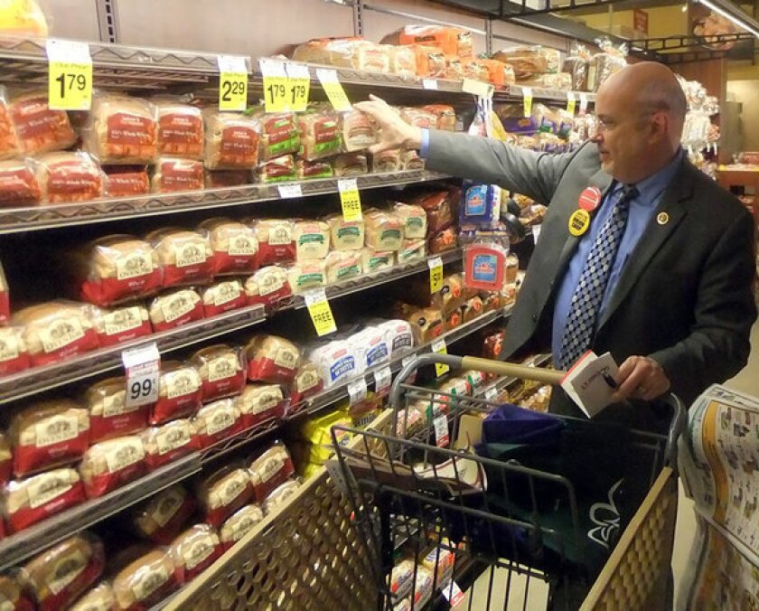 Rep. Mark Pocan (D -Wis.) buys food at a Washington, D.C., supermarket as part of a challenge to live on $4.50 in daily food expenses. A group of Democratic representatives are protesting possible cuts to the food stamps program.