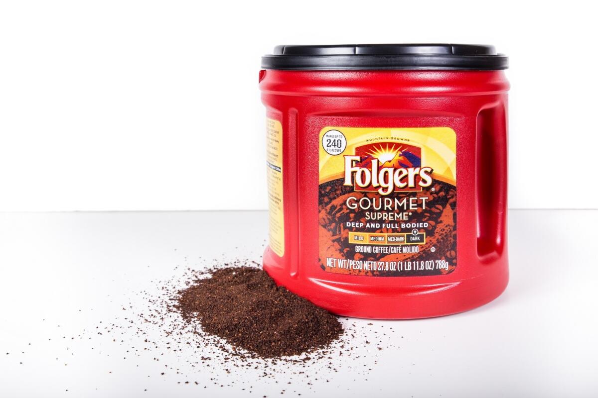 New York City, New York, USA - July 9, 2015: Pictured here is a plastic container of Folgers Coffee with loose grinds against a white background. This popular brand of coffee in the United States, part of the food and beverage division of The J.M. Smucker Company.