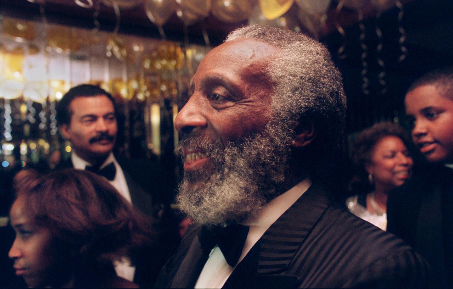 Dick Gregory attends a 50th-anniversary party for actor-activists Ruby Dee and Ossie Davis at a New York hotelin 1998.
