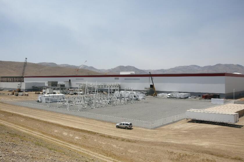 The $5-billion Tesla Gigafactory in Sparks, Nev., began the mass production of lithium-ion battery cells on Wednesday.
