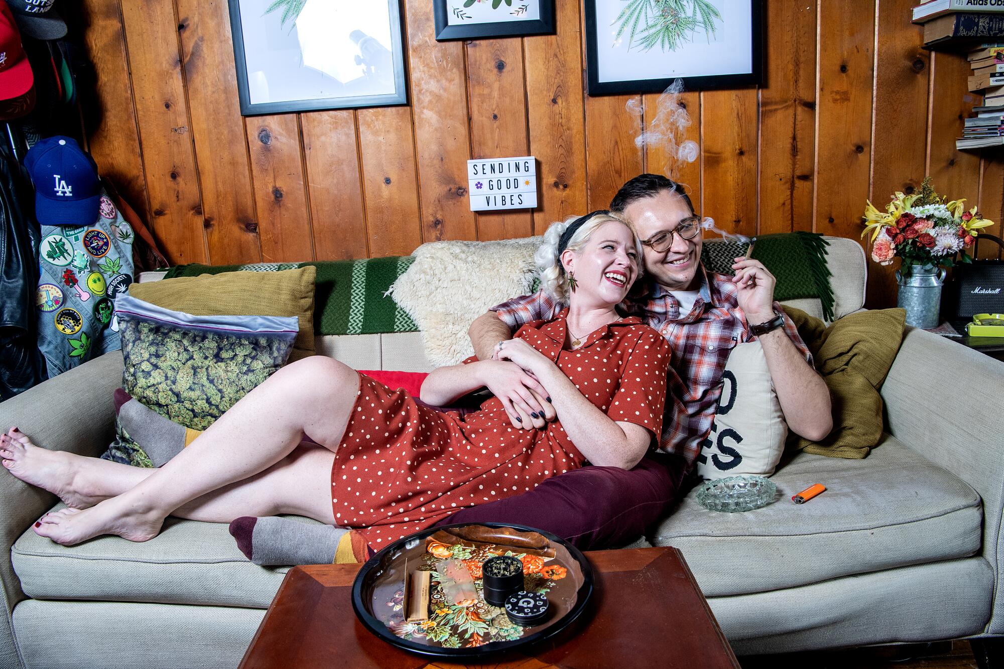 Clark and Alice Campbell lie on a couch inside their Hollywood apartment.