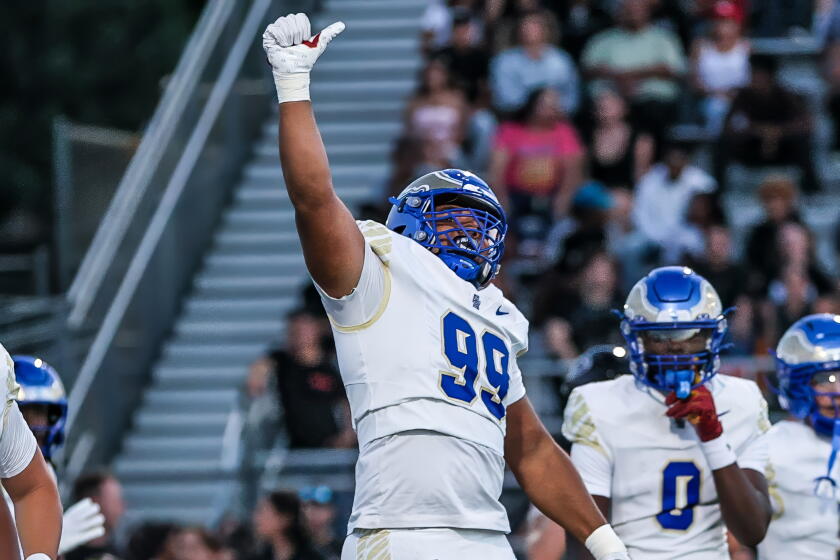 Sophomore Kingston Jimmerson of Santa Margarita celebrates after a sack of Centennial QB Jaden Jefferson.