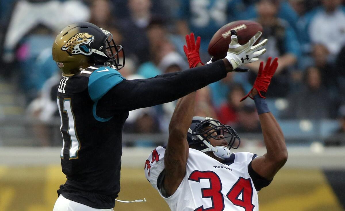 Jaguars receiver Marqise Lee catches a pass over Texans cornerback A.J. Bouye on Dec. 7. On Monday, Lee and several other former Trojans playing in the NFL enrolled in classes at USC.