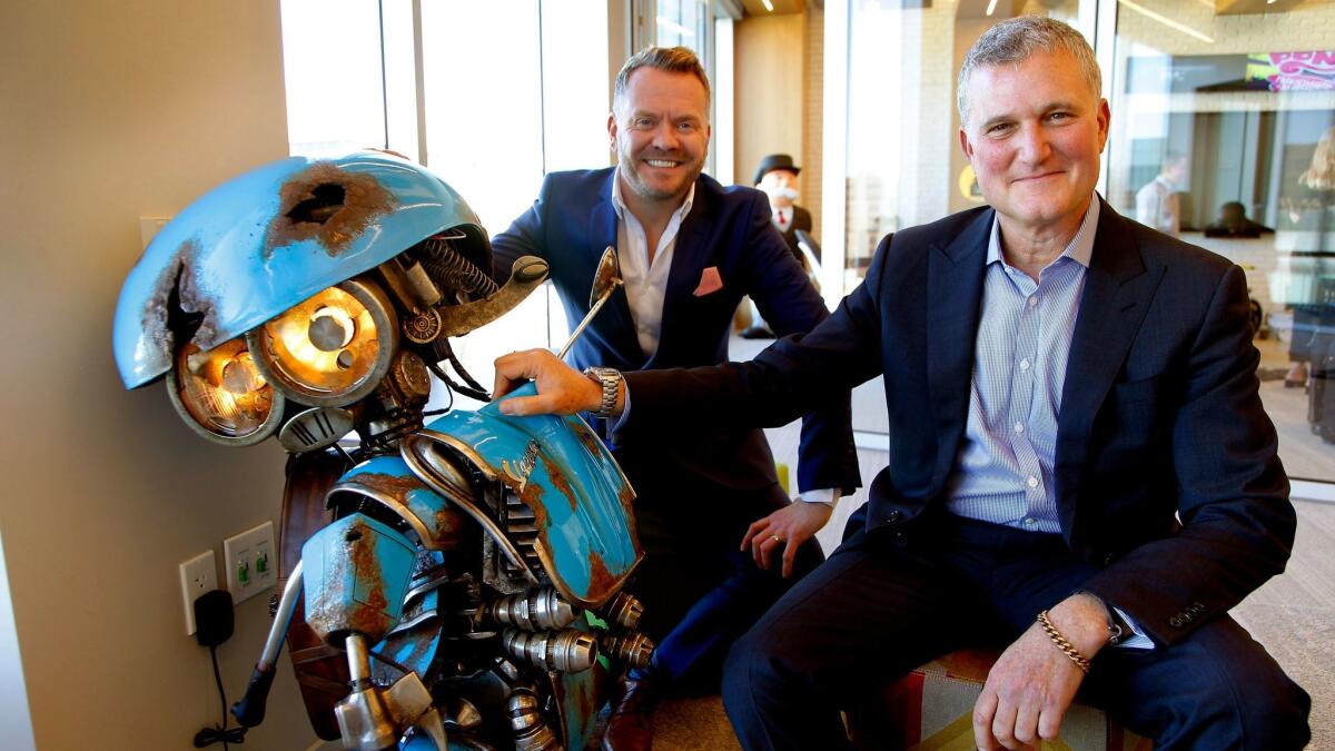 Hasbro executives Simon Waters (Global Brand Licensing), Steve Davis (Chief Content Officer) and with SQUEAKS (a Vespa scooter), a new Transformer for the up coming "Transformer" movie