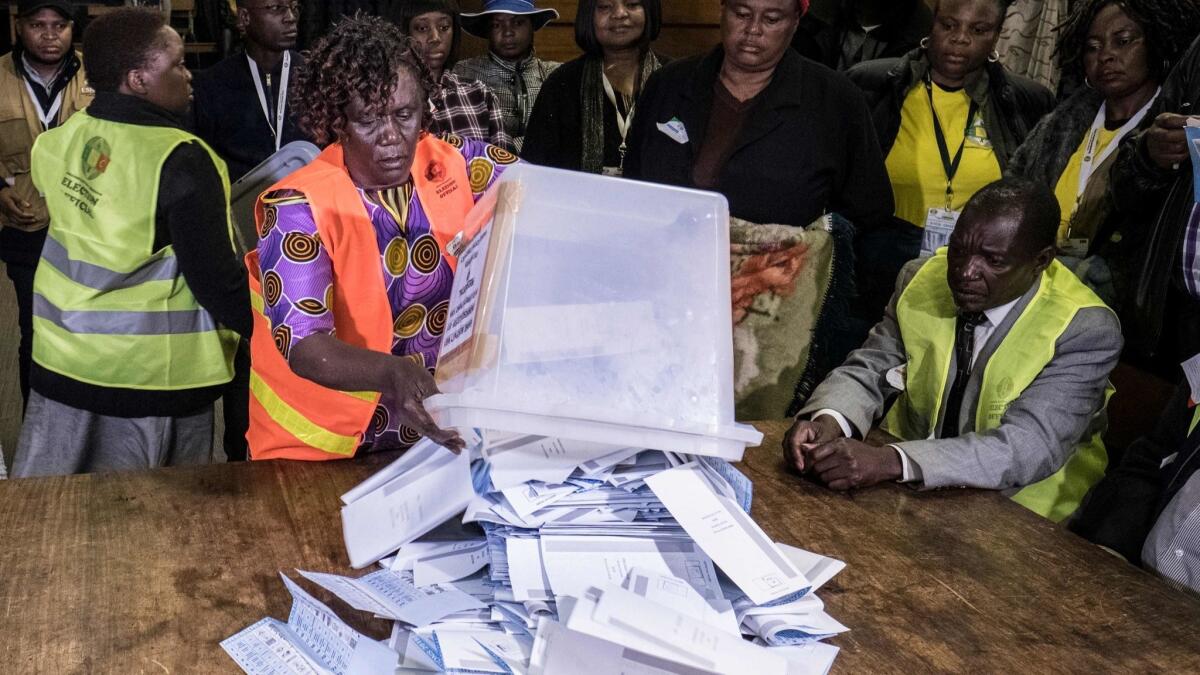 Zimbabwean electoral workers prepare to count ballots at the David Livingston elementary school in central Harare.