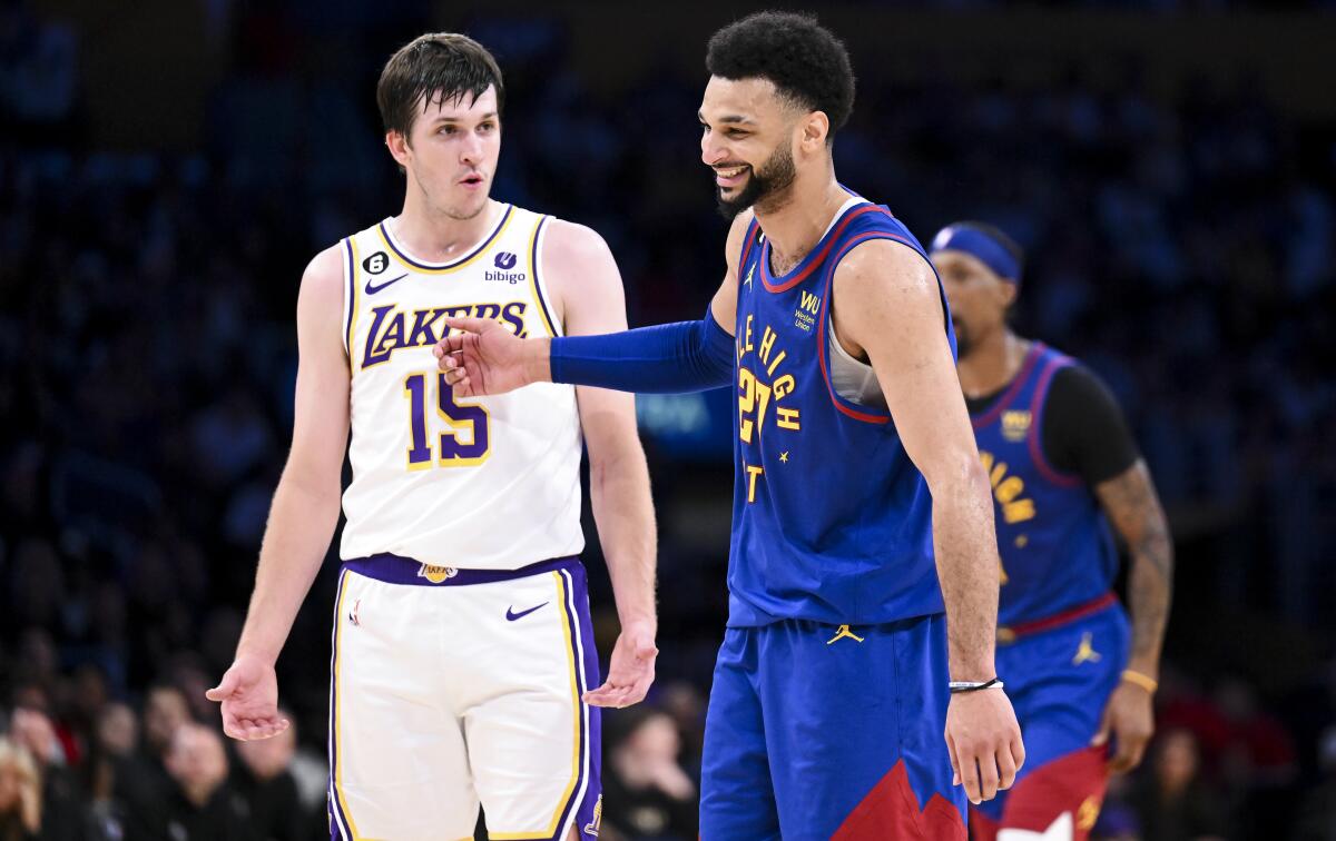 Lakers guard Austin Reaves, left, has a few words with Nuggets guard Jamal Murray.