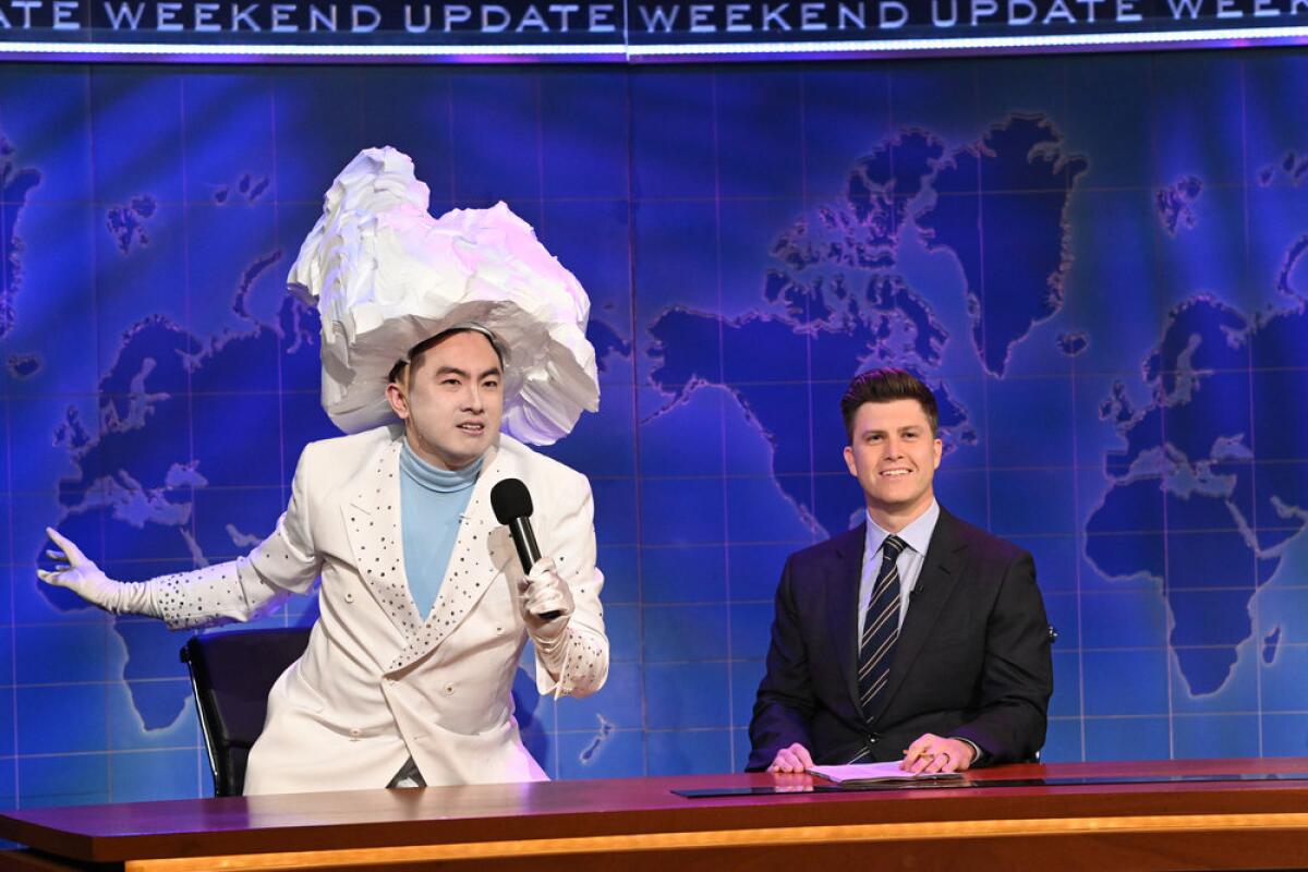 Bowen Yang as The Iceberg That Sank the Titanic and Weekend Update anchor Colin Jost.(Photo by: Will Heath/NBC)