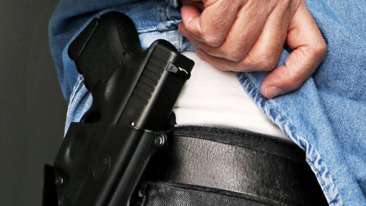 A lawsuit filed Wednesday seeks to block a California law that prevents most people from carrying guns openly in public.