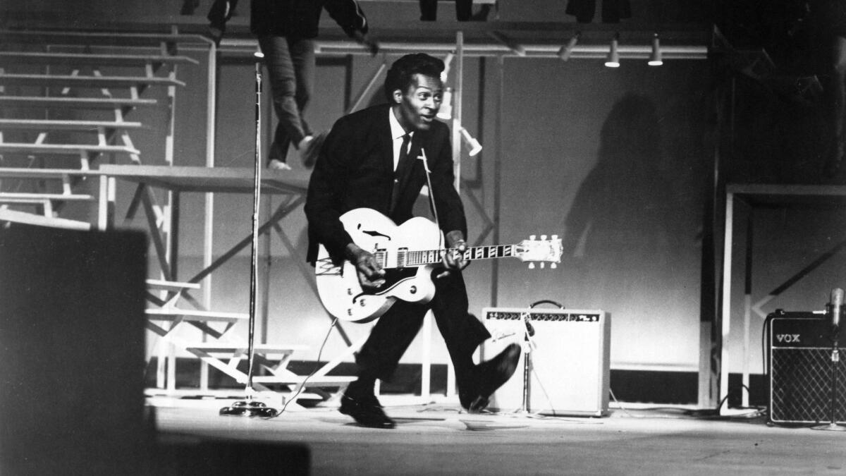 Chuck Berry performs his "duck walk" at a performance in Santa Monica in 1964. (Michael Ochs Archives / Getty Images)