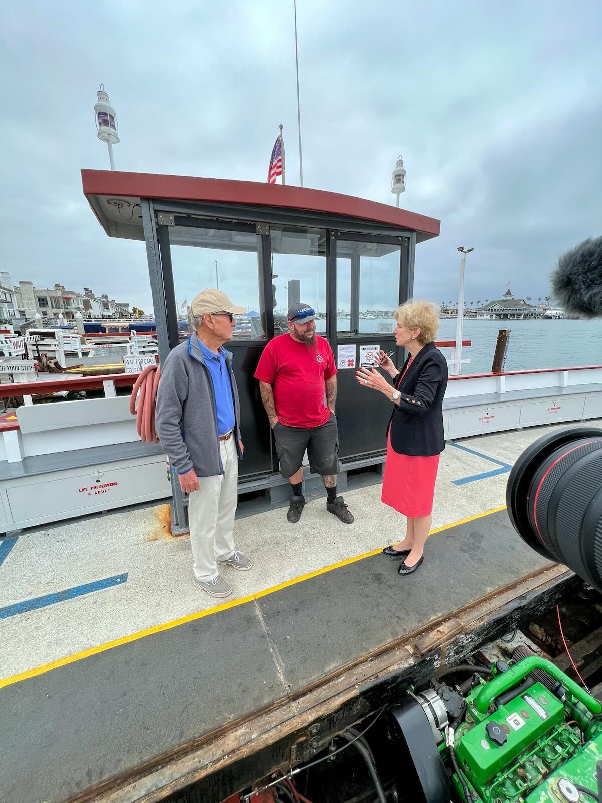 Assemblywoman Diane Dixon (R-Newport Beach), right, speaks with staff.