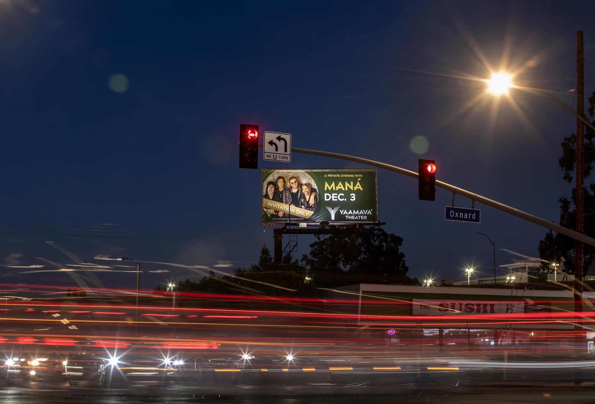 A billboard promoting the band Mana