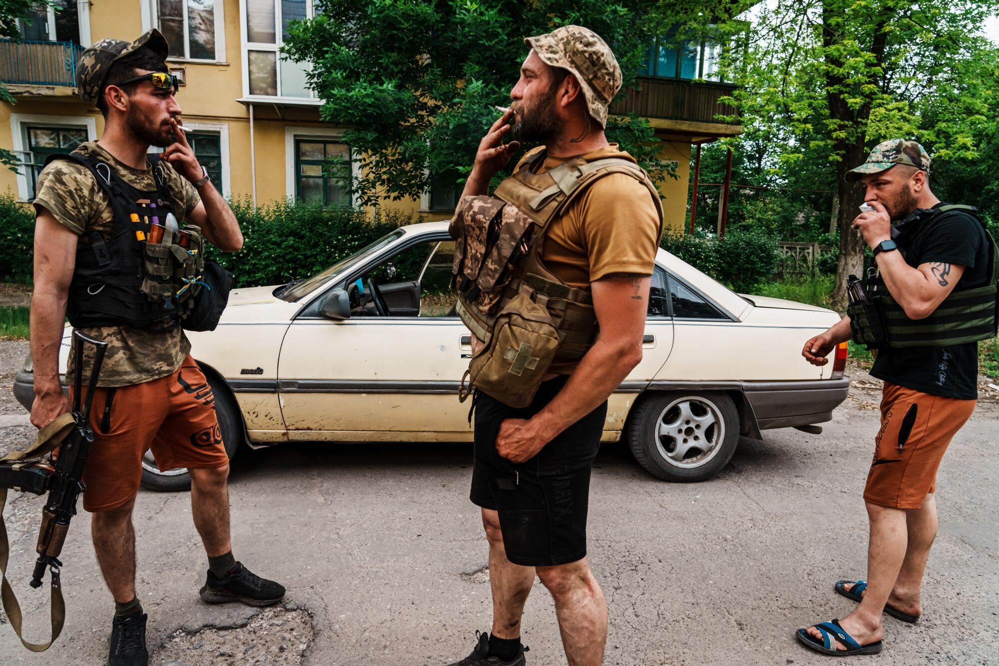 Armed men smoke cigarettes near the town center of Siversk, Ukraine.