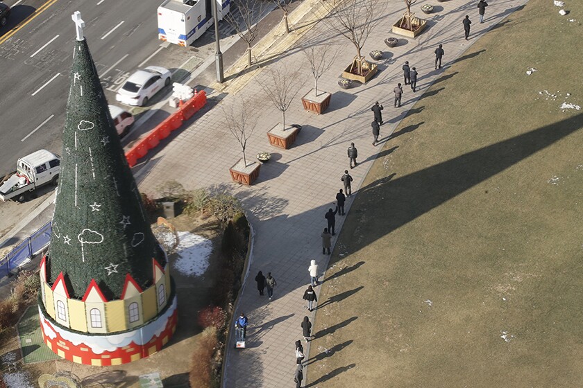 People line up for coronavirus testing in Seoul.