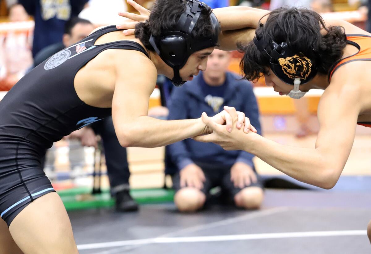 Marina's Adrian Jimenez, left, and Central's Anthony Castillo grapple in the 113-pound final of the Mann Classic.