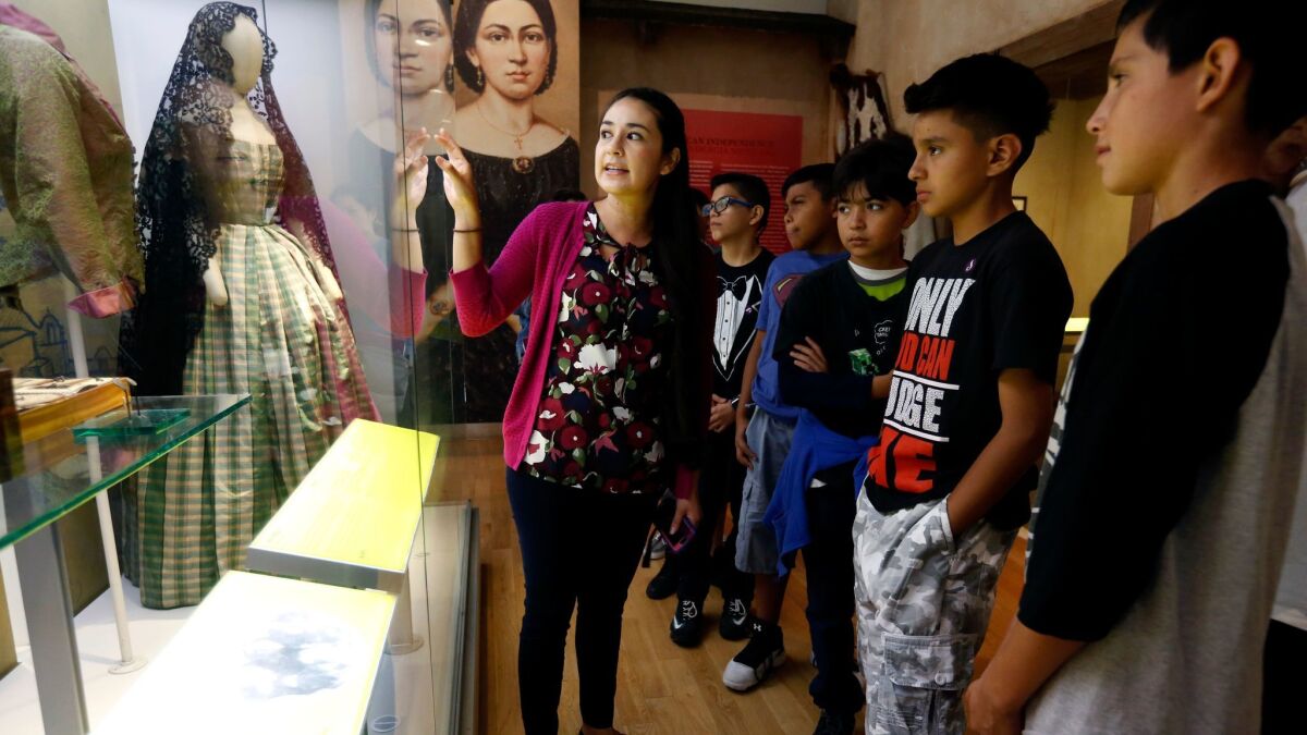 Gina Alicia López Ramos gives a tour of La Plaza de Cultura y Artes to students visiting from South Gate's Southeast Middle School.