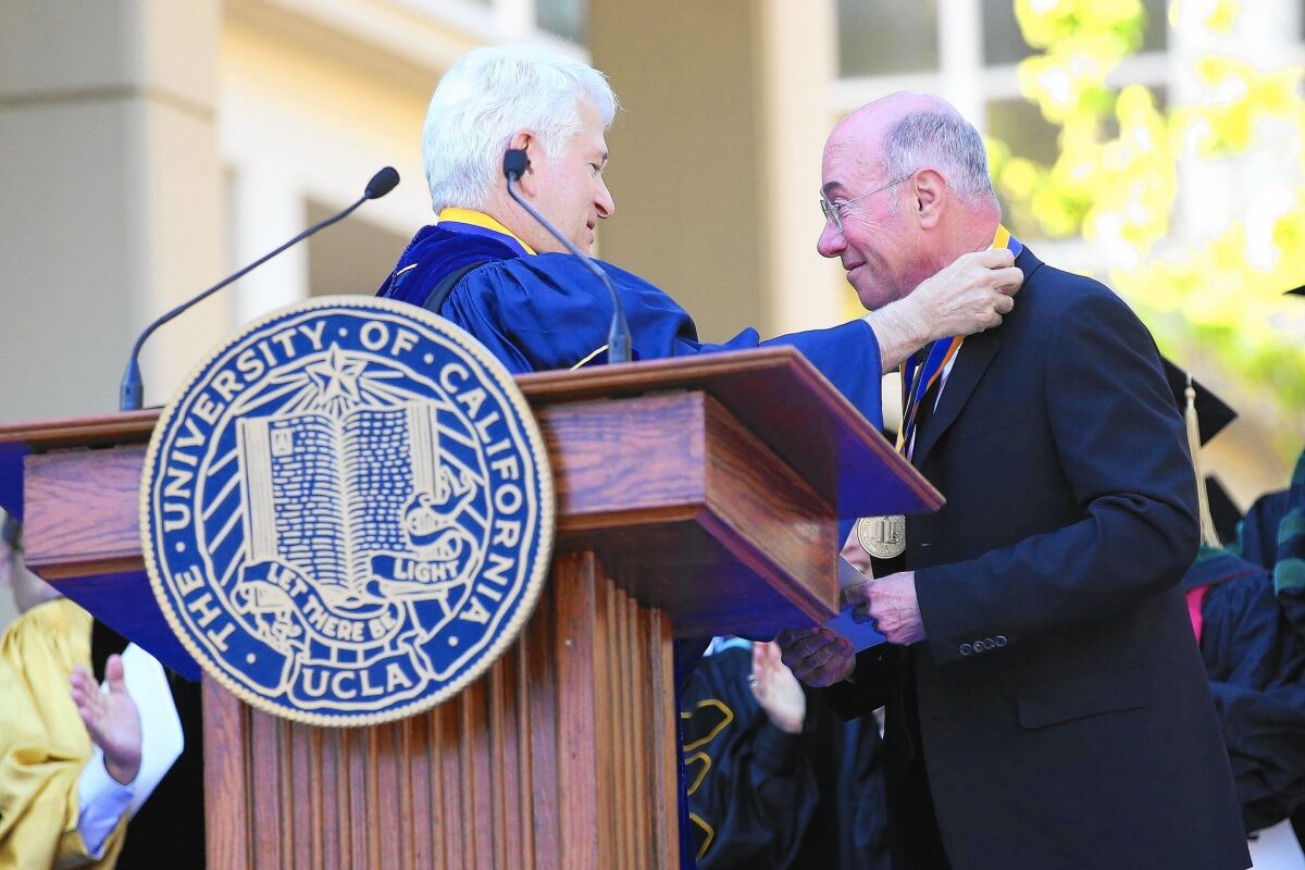 UCLA Chancellor Gene Block, left, presents an award to David Geffen in 2014. Geffen has donated more than $400 million to the university, mostly for the medical school.