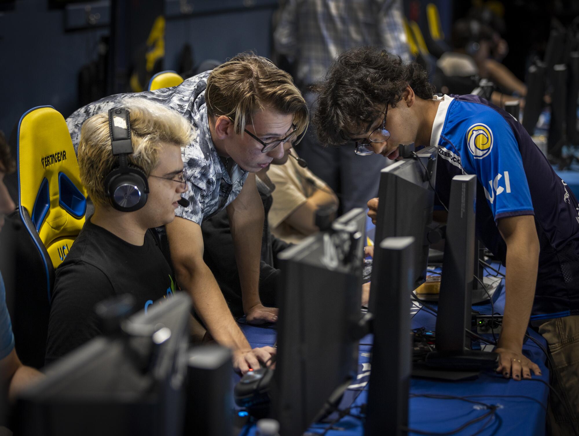 UCI students Dimitri Karanikas, Sean Cook and Zuhair "Zeerocious" Taleb problem solve between playing Overwatch 2.