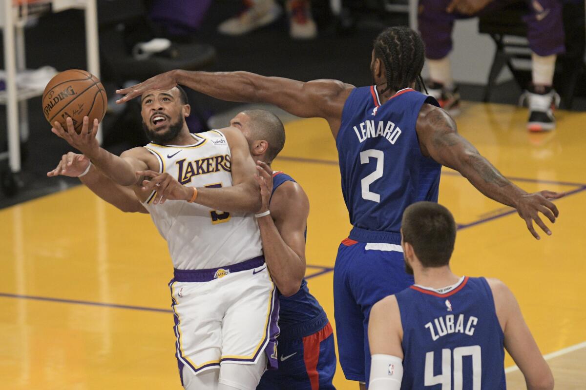 Lakers guard Talen Horton-Tucker draws a foul as he shoots under pressure.
