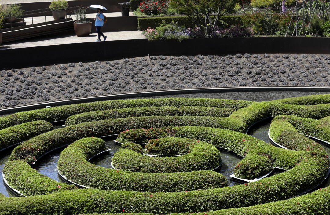 Jennifer Conway, top, walks in the garden at the Getty Center.