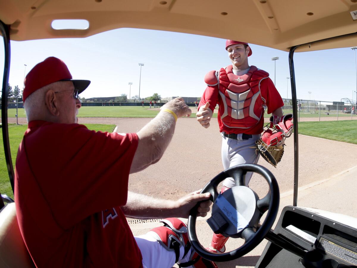 Angels catching coordinator Bill Lachemann greets then-minor league catcher Jett Bandy before a spring training game in 2013. The Angels on Thursday added Bandy to its 40-man roster.