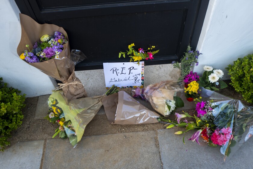 Flowers and a letter saying "RIP Gabriel" are left on a doorstep