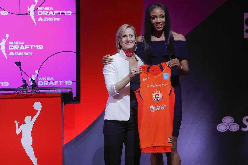 Kristine Anigwe, right, poses for a photo with WNBA COO Christy Hedgpeth after being selected by the Connecticut Sun as the ninth overall pick in the WNBA basketball draft Wednesday, April 10, 2019, in New York. (AP Photo/Julie Jacobson)
