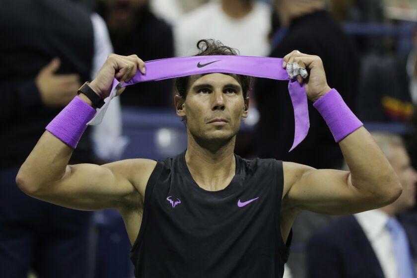 Rafael Nadal, of Spain, adjusts his headband during a break between games against Matteo Berrettini, of Italy, at the men's singles semifinals of the U.S. Open tennis championships Friday, Sept. 6, 2019, in New York. (AP Photo/Adam Hunger)