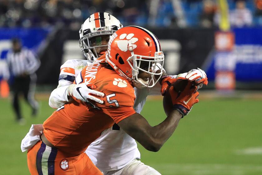 CHARLOTTE, NORTH CAROLINA - DECEMBER 07: Tee Higgins #5 of the Clemson Tigers makes a catch against Nick Grant #1 of the Virginia Cavaliers during the ACC Football Championship game at Bank of America Stadium on December 07, 2019 in Charlotte, North Carolina. (Photo by Streeter Lecka/Getty Images) ** OUTS - ELSENT, FPG, CM - OUTS * NM, PH, VA if sourced by CT, LA or MoD **
