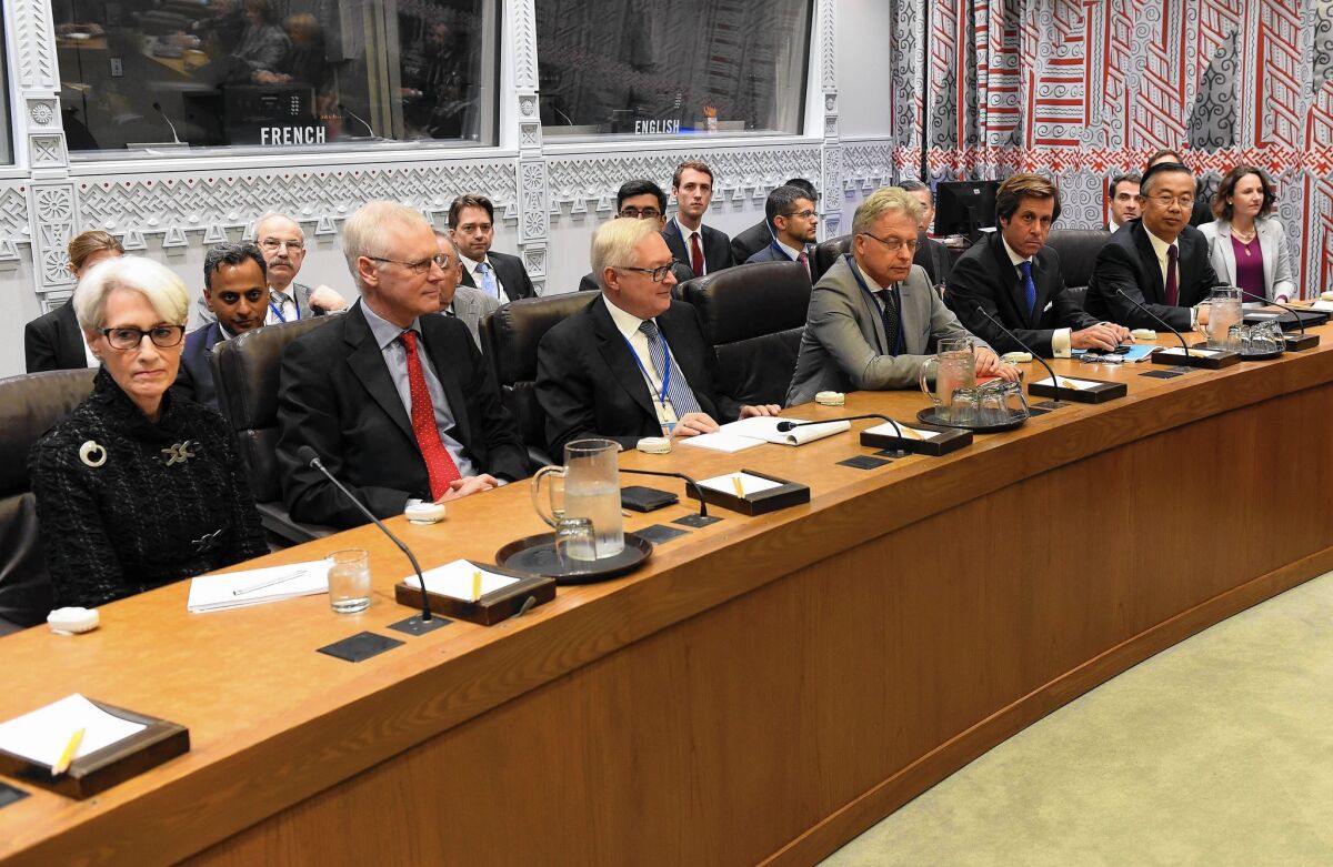 Negotiators Wendy Sherman, left, of the U.S., Simon Gass of Britain, Sergei Ryabkov of Russia, Hans-Dieter Lucas of Germany, Nicolas DeRiviere of France and Wang Min of China attend a meeting at the U.N. about Iran.