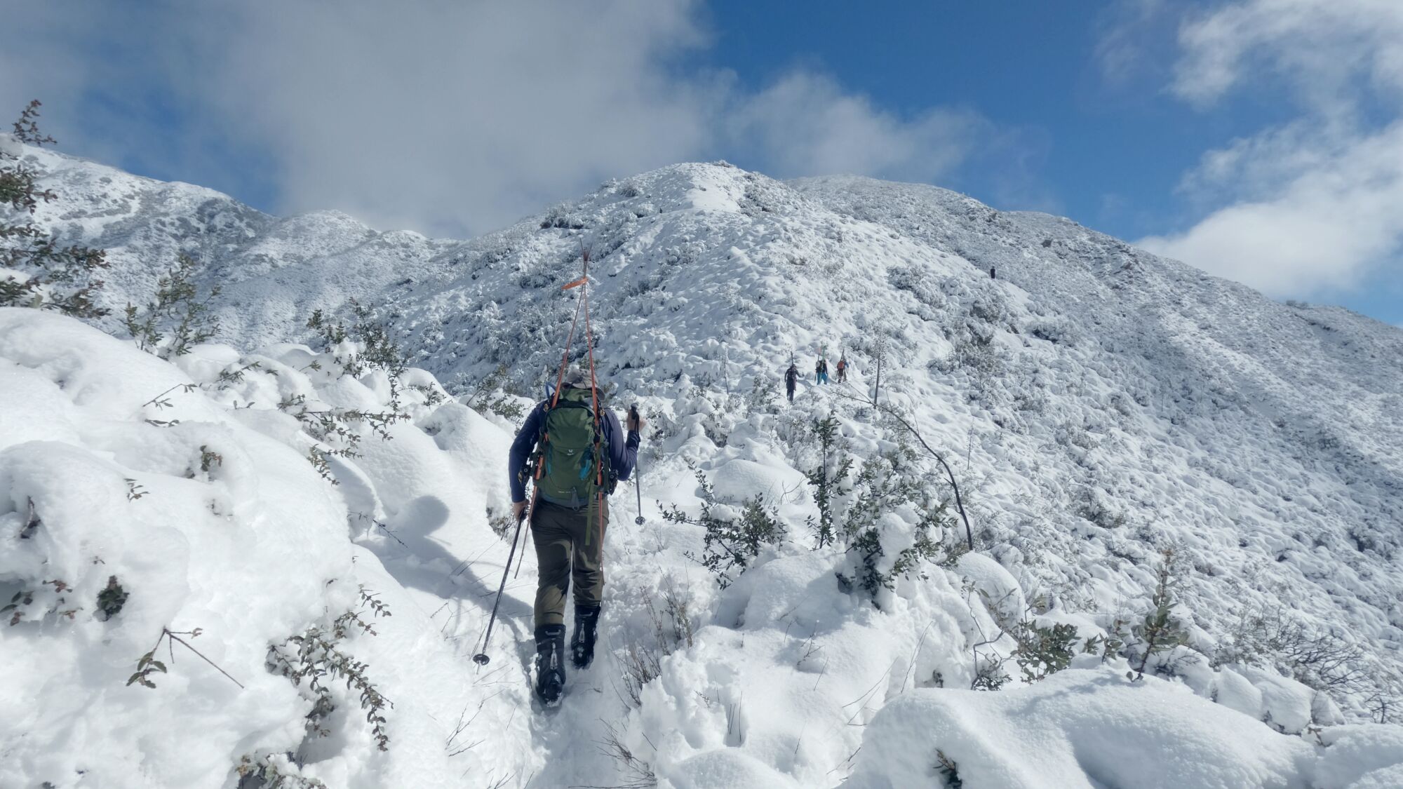Skiers make their way to the summit of Mt. Lukens on Sunday.