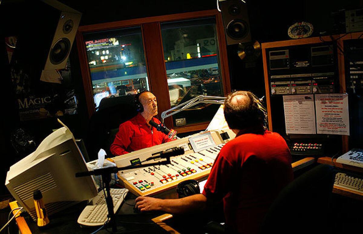 Radio legend Art Laboe, left, and producer Tom Peniston inside Laboe's Hollywood studio. His show ranks near the top in its evening time slot, according to Arbitron ratings, and is popular among listeners 25 to 54 years old.