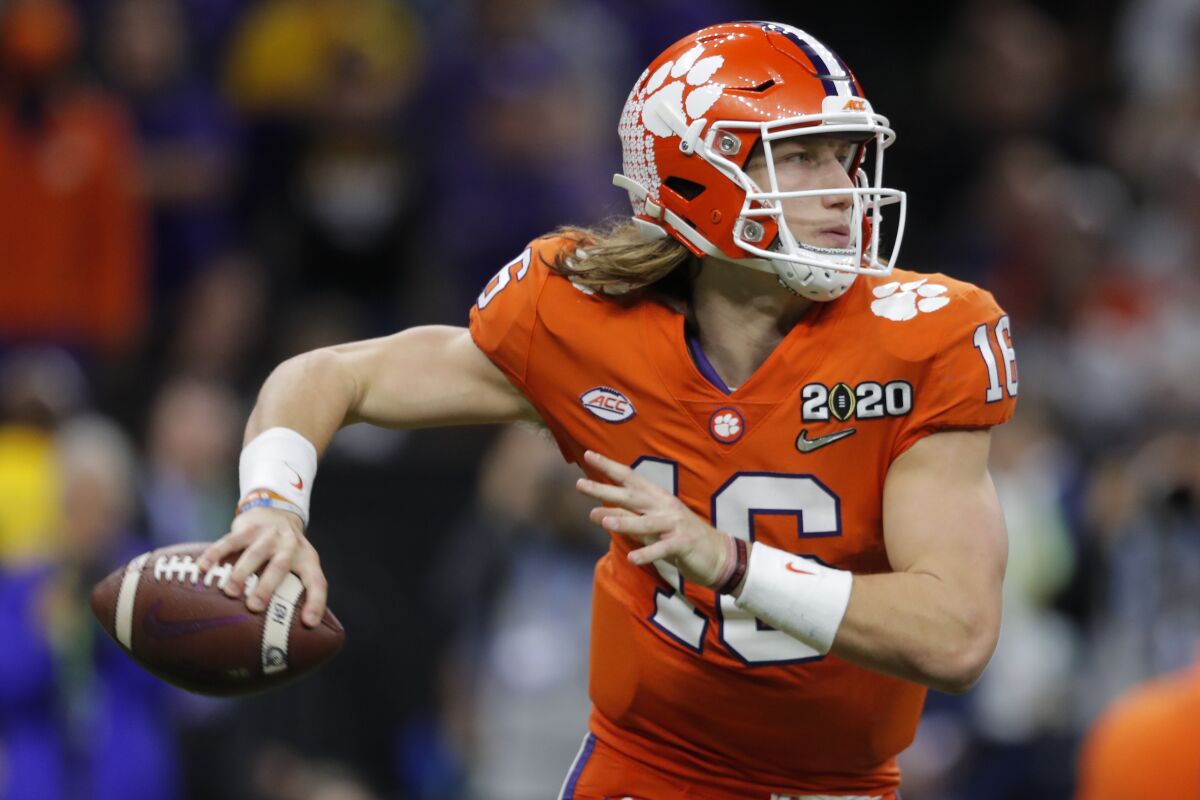 FILE - In this Jan. 13, 2020, file photo, Clemson quarterback Trevor Lawrence looks to pass against LSU during the second half of an NCAA College Football Playoff national championship game in New Orleans. The top-ranked Tigers are 29-1 over the past two seasons and have won five straight ACC championships. (AP Photo/Gerald Herbert, File)