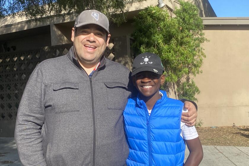 Pierre Campa (right) was adopted by Eddie Campa from Haiti when he was 18 months old and is now a promising junior golfer.