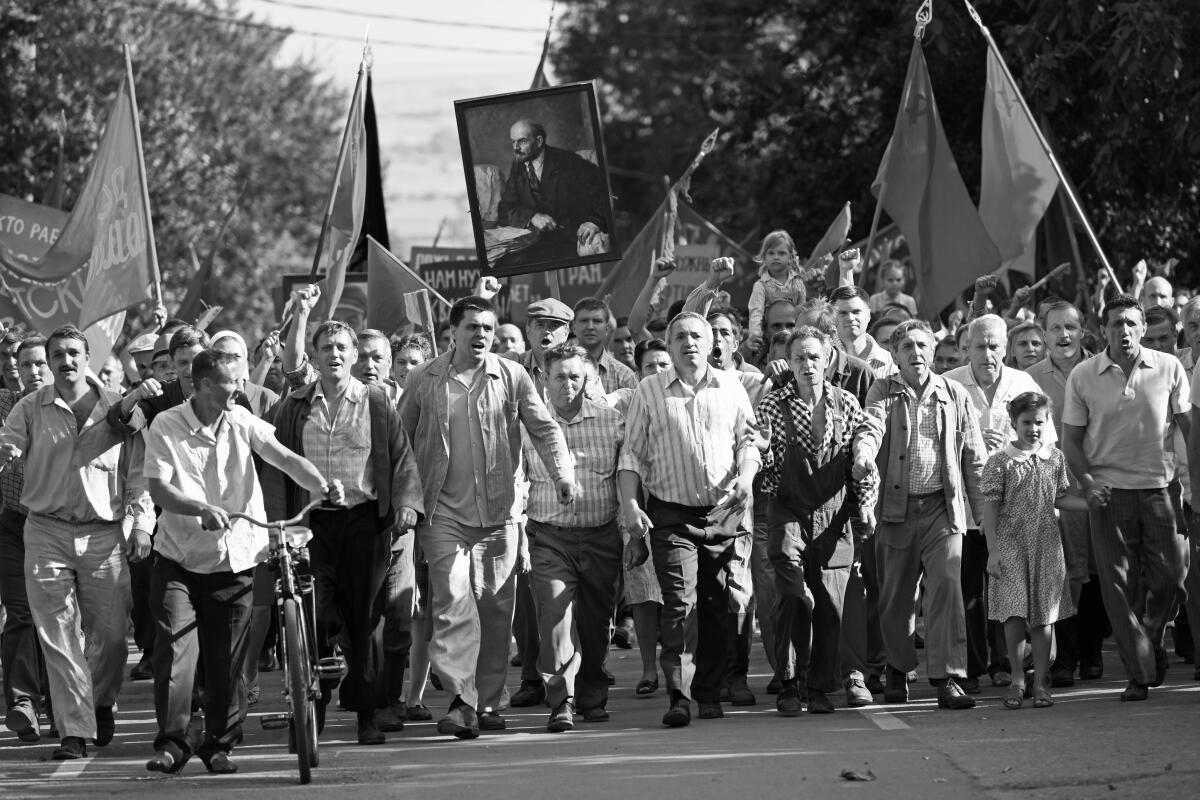 Protesters march through the Russian city of Novocherkassk in the movie "Dear Comrades!"