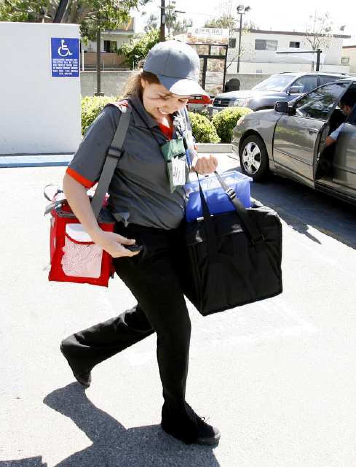 Patricia Camacho makes a delivery at Burger King on Central Avenue in Glendale.