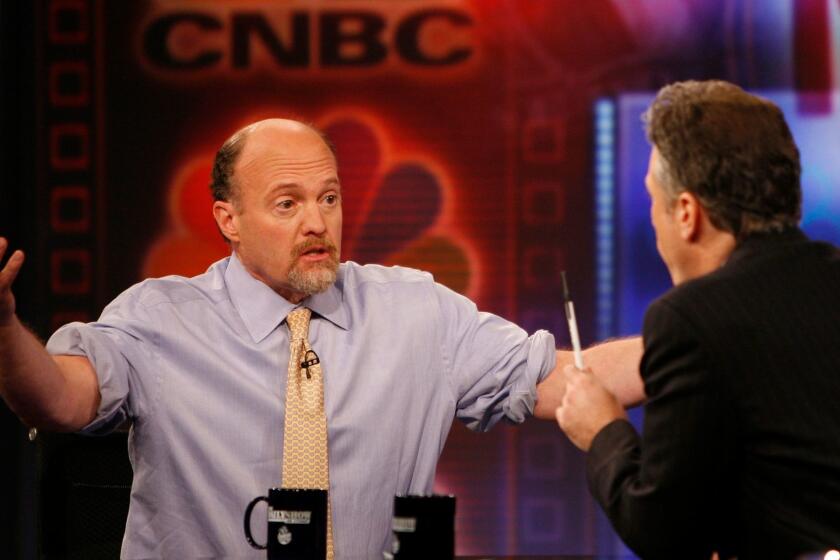 Jim Cramer, left, host of "Mad Money" on CNBC and co-founder of TheStreet Inc., talks with Jon Stewart during an appearance on Comedy Central's "The Daily Show" in 2009.