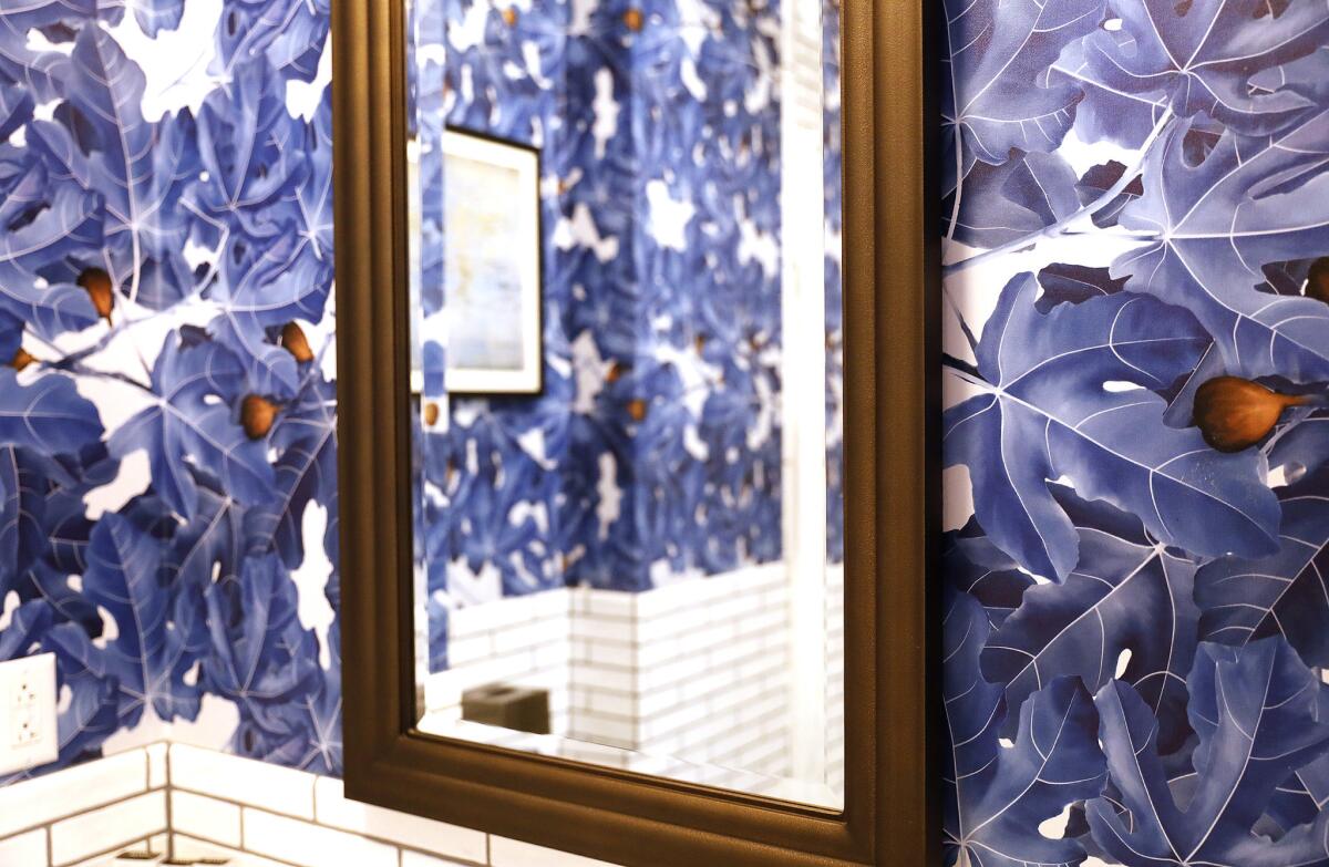 Blue, fig-leaf wallpaper in a guest bathroom at Hotel Figueroa.