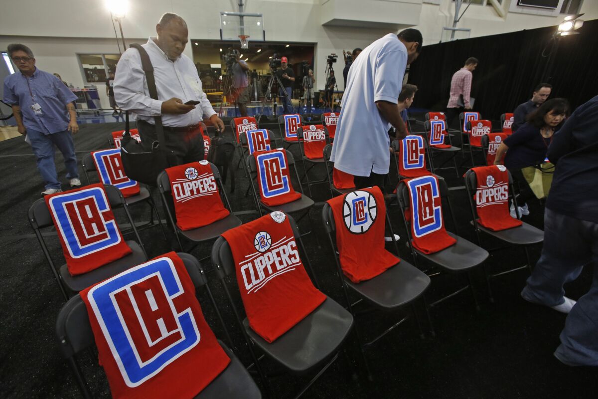 The new Clippers logo is seen on T-shirts at a news conference at the Clippers' training facility in Playa Vista on June 18.