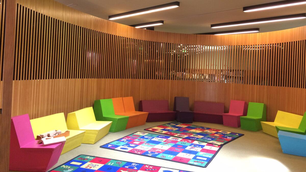 The second story, built at a smaller scale for kids, features this colorful storytelling area